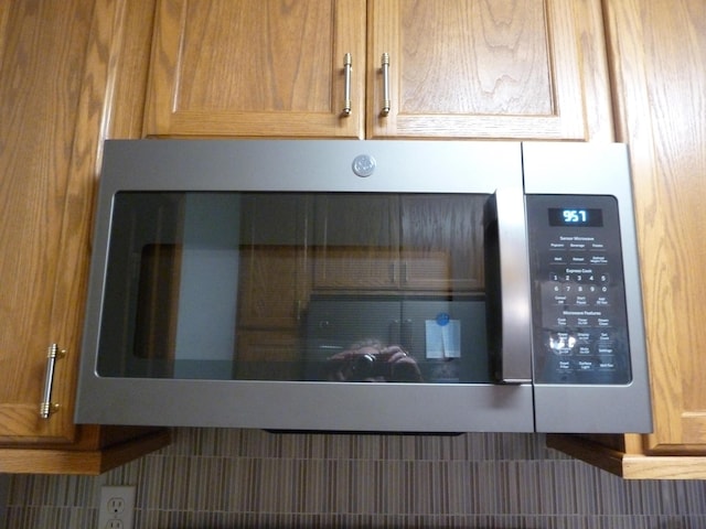 14600 W Diane Dr, Camden, MI 49232 - detailed view of stainless steel microwave and brown cabinetry