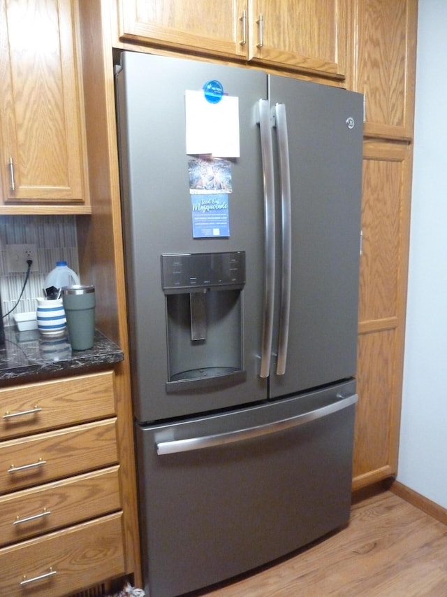 kitchen with stainless steel fridge and light wood-type flooring