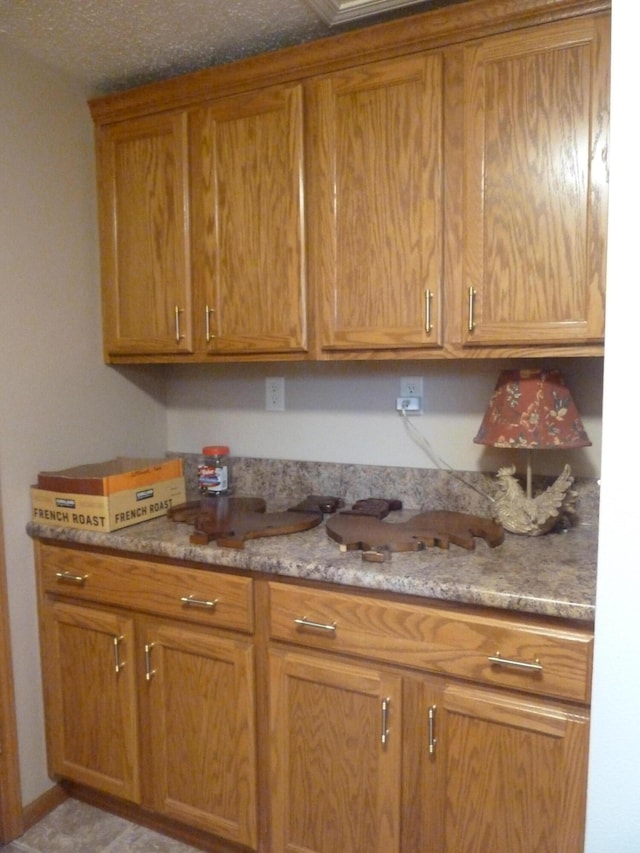 14600 W Diane Dr, Camden, MI 49232 - kitchen with brown cabinetry and light stone counters