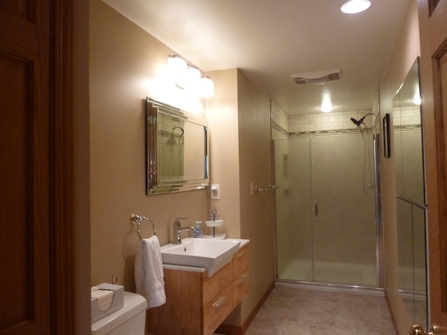 bathroom with vanity, toilet, and walk in shower