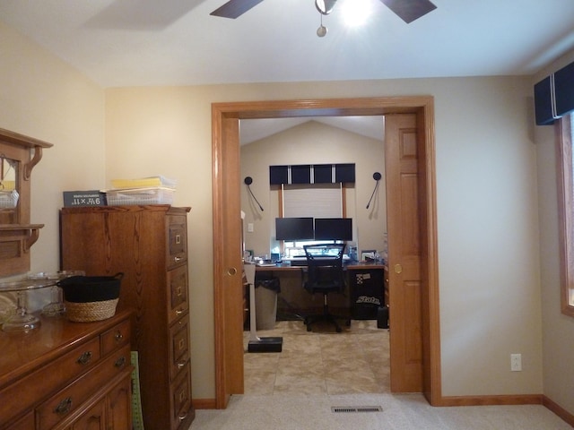 home office with light carpet, vaulted ceiling, and ceiling fan