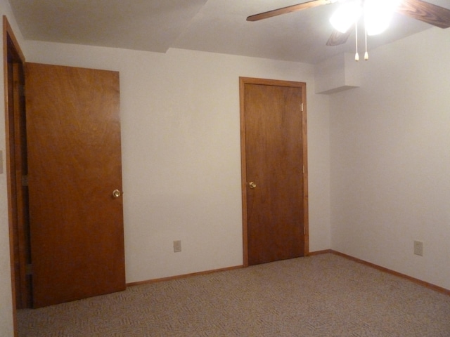 unfurnished bedroom featuring carpet, a closet, and ceiling fan