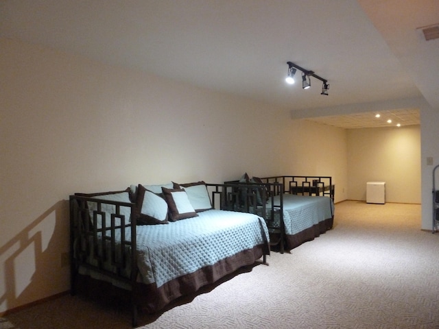 bedroom with carpet flooring and rail lighting