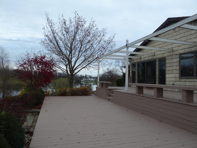 wooden terrace featuring a water view