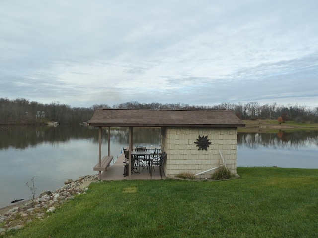 dock area with a lawn and a water view