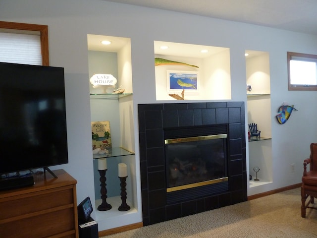 living room featuring carpet floors and a tile fireplace