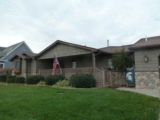 ranch-style house with a porch and a front yard