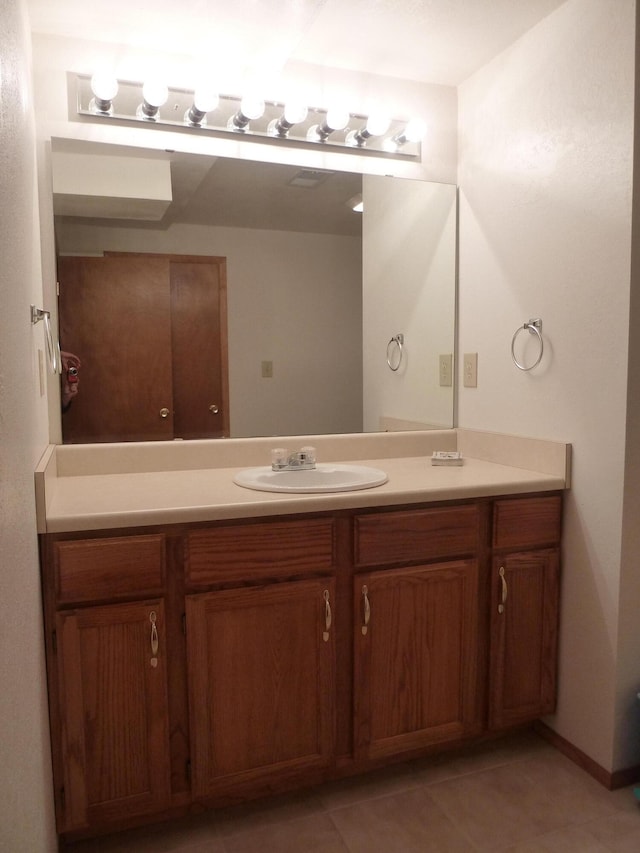 bathroom featuring tile patterned flooring and vanity