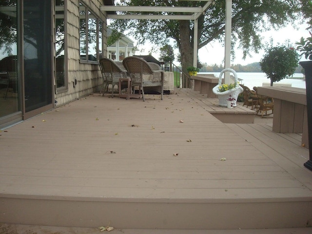 wooden terrace featuring a water view