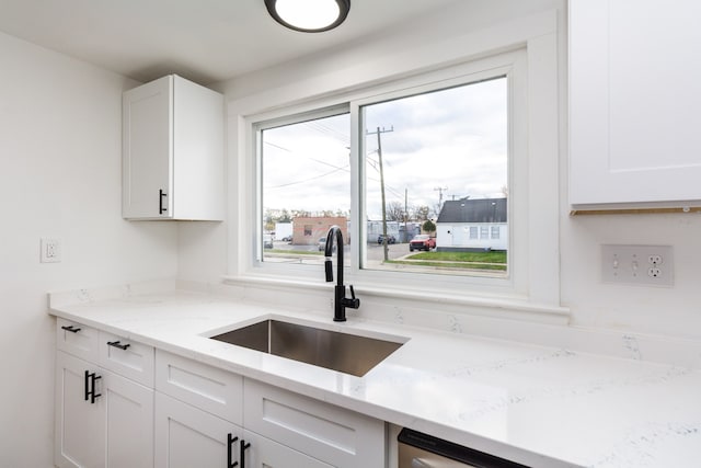 7641 Westminster Ave, Warren, MI 48091 - kitchen featuring a sink, white cabinetry, and light stone countertops