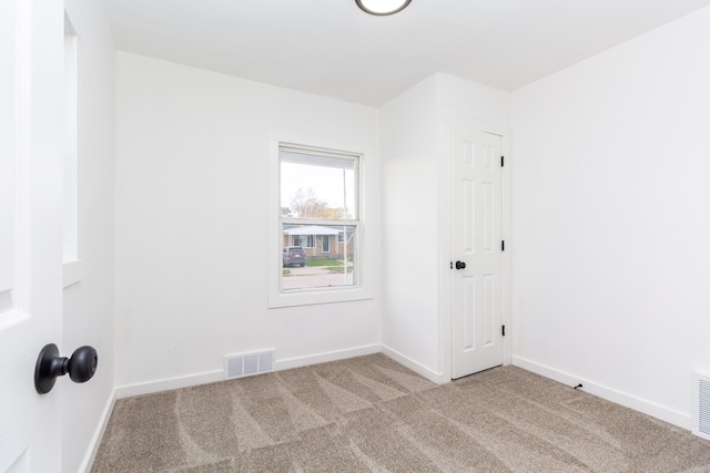 unfurnished room with light carpet