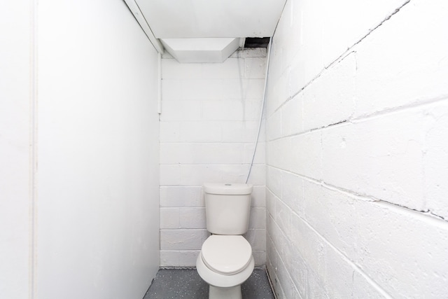 7641 Westminster Ave, Warren, MI 48091 - bathroom featuring concrete block wall and toilet