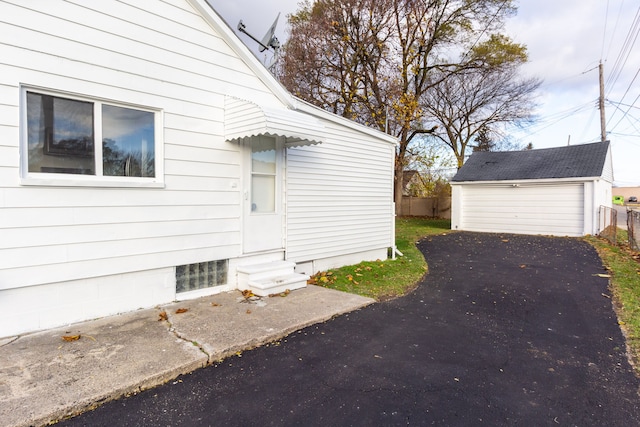 view of property exterior with a garage and an outdoor structure