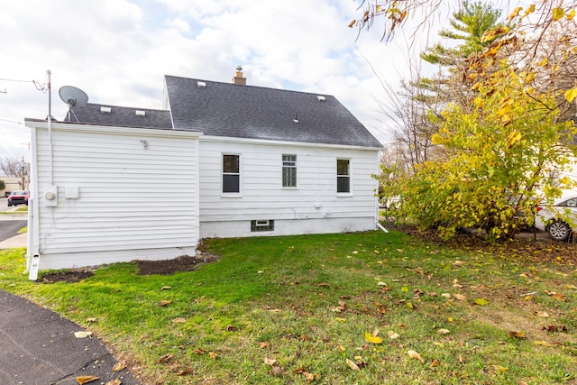 back of property featuring a lawn