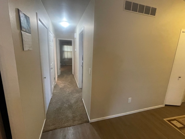 corridor featuring dark hardwood / wood-style floors