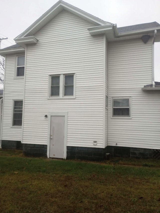 rear view of property with a lawn