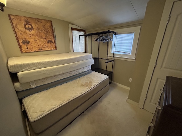 carpeted bedroom with vaulted ceiling