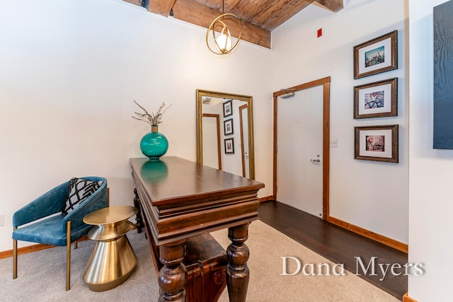 office area featuring beam ceiling, dark wood-type flooring, and wood ceiling