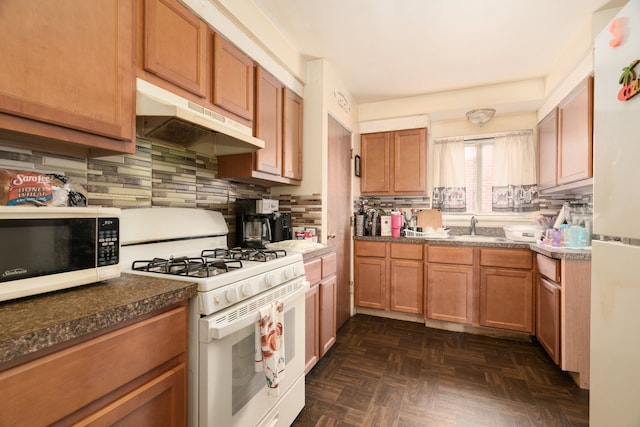 kitchen with tasteful backsplash, dark parquet flooring, sink, and white appliances