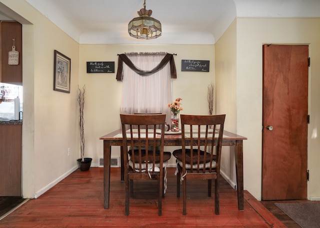 dining area with dark hardwood / wood-style flooring