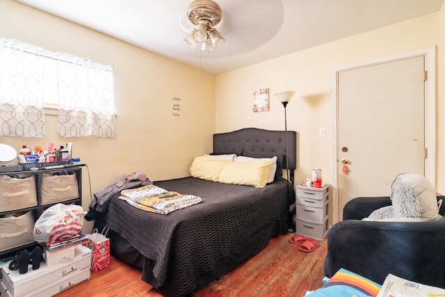 bedroom with hardwood / wood-style floors and ceiling fan