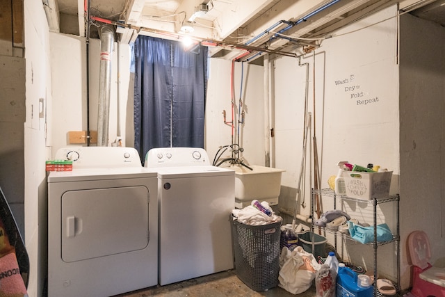 washroom with washing machine and dryer and sink