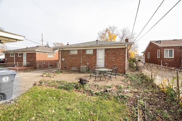 rear view of property with cooling unit and a patio area