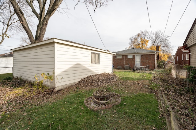 back of property with a yard and cooling unit