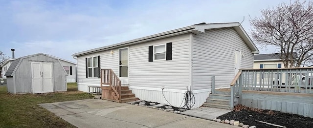 back of property with a patio area, a storage shed, and a wooden deck