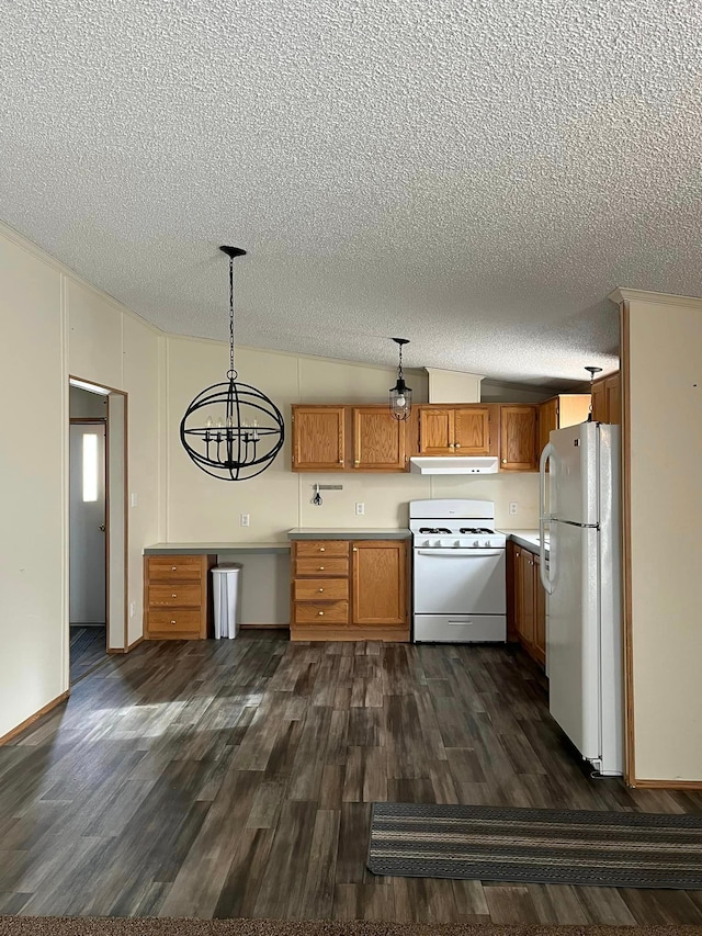 kitchen featuring pendant lighting, white appliances, vaulted ceiling, dark hardwood / wood-style floors, and a textured ceiling