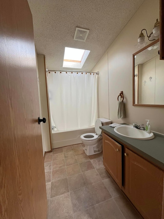 full bathroom with vanity, a textured ceiling, a skylight, and shower / bath combo with shower curtain