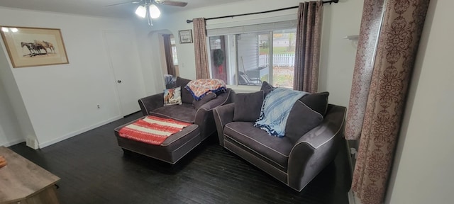 living room featuring dark hardwood / wood-style floors and ceiling fan