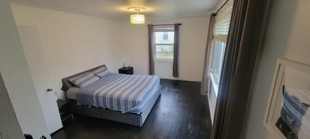 bedroom with dark hardwood / wood-style floors