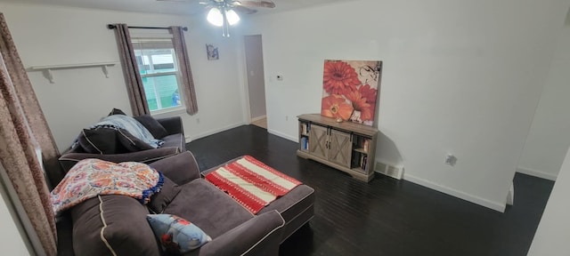 living room with dark hardwood / wood-style flooring and ceiling fan