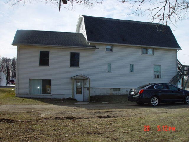 back of house with a lawn