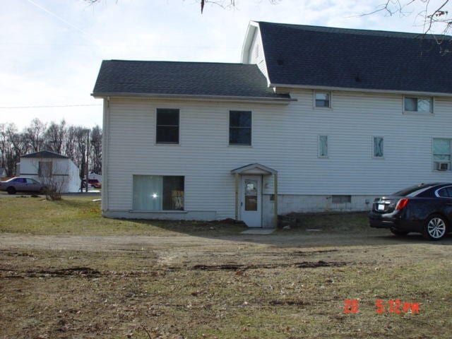 rear view of house with a lawn