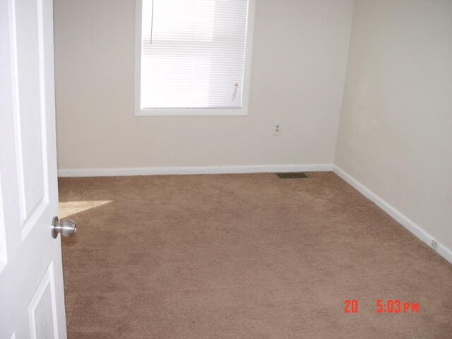 unfurnished room with carpet floors