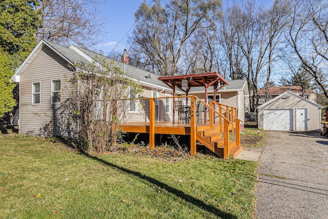 rear view of property with a lawn, a garage, an outdoor structure, and a deck