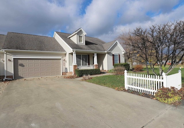 cape cod-style house featuring a porch, a garage, and a front lawn