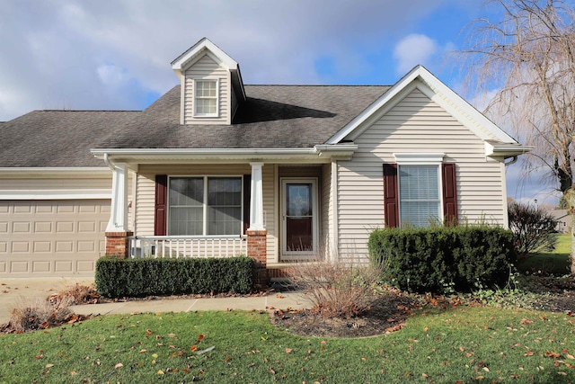 view of front of property with a garage, a porch, and a front yard