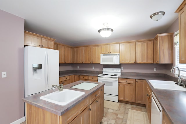 kitchen with a center island, white appliances, and sink