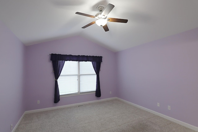 carpeted empty room featuring ceiling fan and lofted ceiling