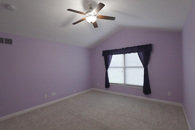 empty room featuring ceiling fan, lofted ceiling, and light carpet