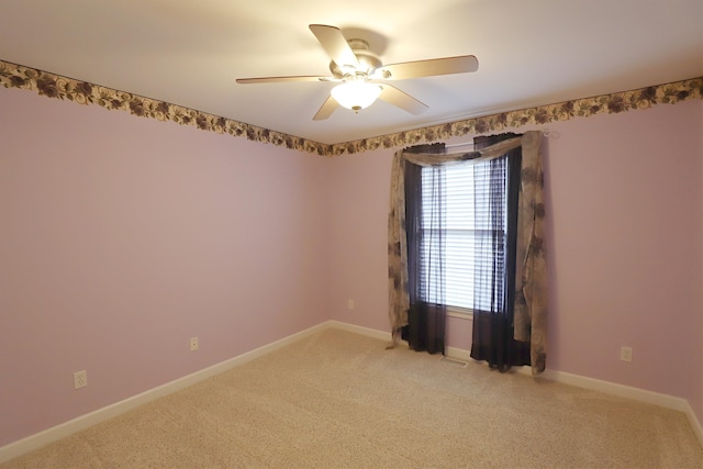 unfurnished room featuring ceiling fan and light carpet