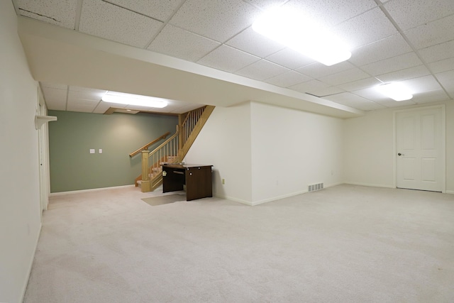 basement with carpet flooring and a drop ceiling