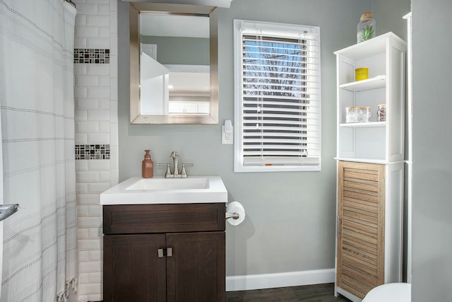 bathroom with vanity, hardwood / wood-style flooring, and curtained shower