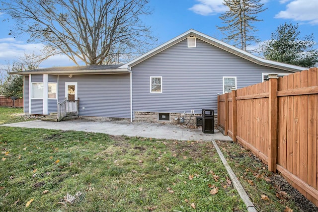 rear view of property featuring a yard and a patio area