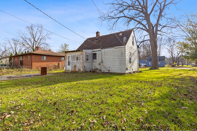 back of property with a lawn