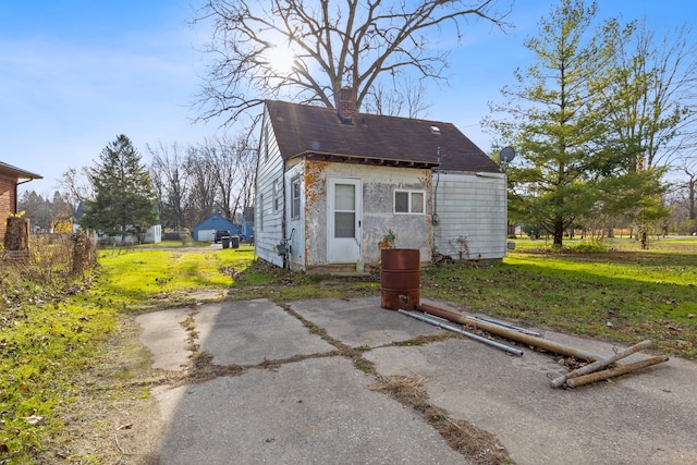 25370 Mary St, Taylor, MI 48180 - rear view of property with a chimney and a lawn