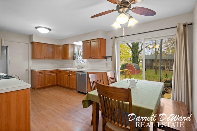 kitchen featuring appliances with stainless steel finishes, light hardwood / wood-style floors, plenty of natural light, and ceiling fan